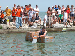 Ryan Snyder of Celina paddles his way to victory during the third annual Cardboard Duck Tape Boat Race held Saturday afternoon during the Celina Lake Festival. Snyder and his brother, Jason, took first place and were honored for their accomplishment with a ride on a parade float Saturday night.&nbsp;&nbsp;<br></br>dailystandard.com