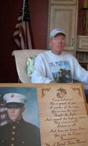 Coldwater resident Nick Kahlig is shown with a photo of his son, Tyler, a U.S. Marine who will return for another tour in Iraq next spring. Kahlig and friend, Nick Ruchty, are running in the Marine Corps Marathon in Washington, D.C., on Sunday in honor of Tyler and other military men and women.&nbsp;&nbsp;<br></br>dailystandard.com